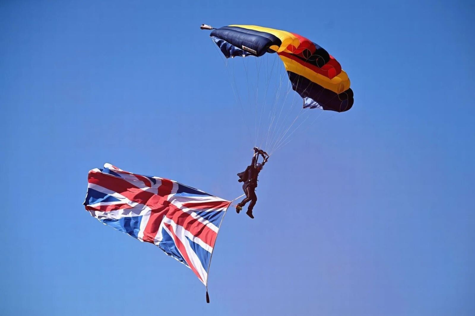 Photograph of a person parachuting with a Union Flag billowing below them